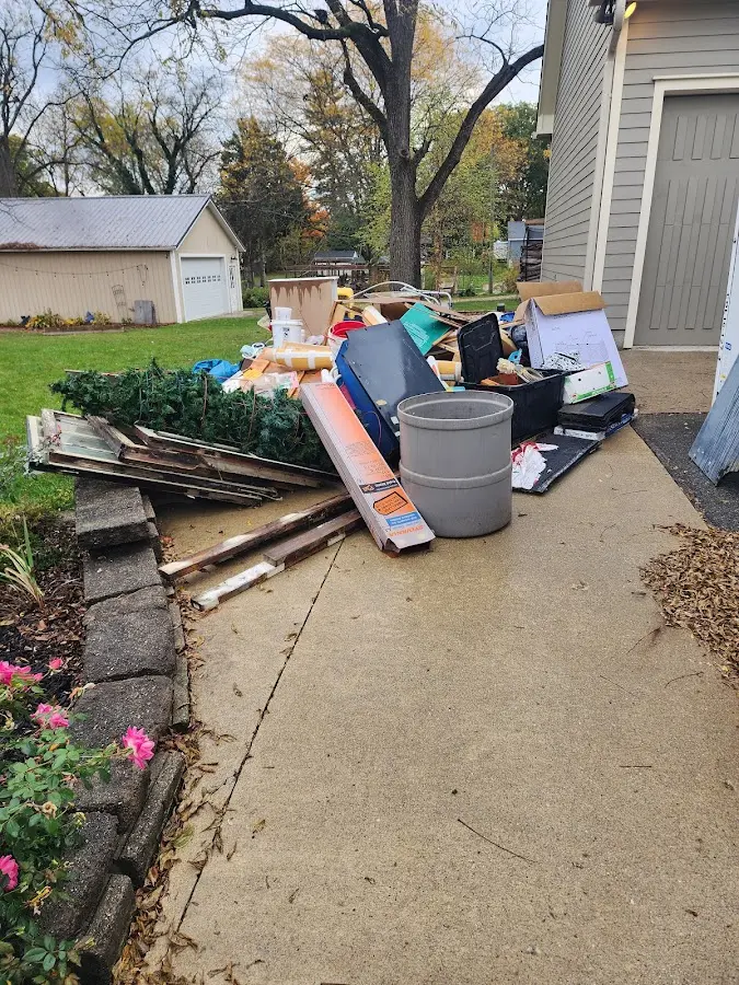 Dumpster being loaded with debris for 3 Yard Dumpster Rental in Hickory Creek